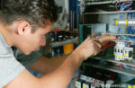 Elektroniker kontrolliert eine Schaltanlage